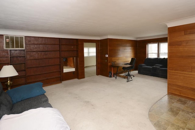 carpeted living room with wooden walls