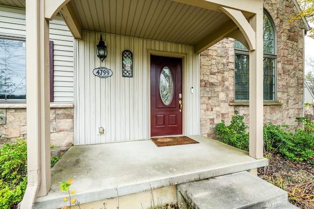 property entrance with stone siding