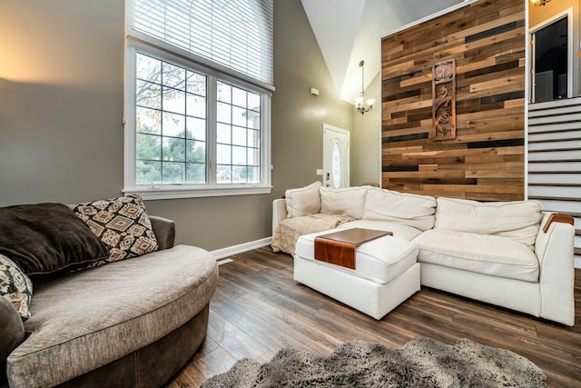 living room with dark wood-style floors, high vaulted ceiling, and baseboards