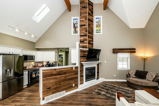 kitchen with dark wood-style floors, visible vents, appliances with stainless steel finishes, open floor plan, and white cabinetry