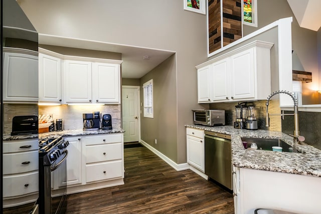 kitchen with white cabinets, black range with gas cooktop, a sink, and stainless steel dishwasher