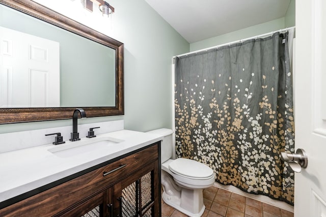 bathroom featuring tile patterned flooring, vanity, and toilet