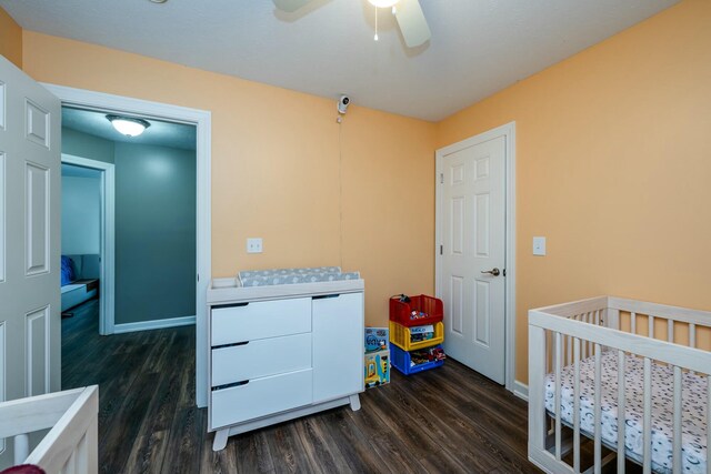 bedroom featuring dark wood-style floors, ceiling fan, and baseboards