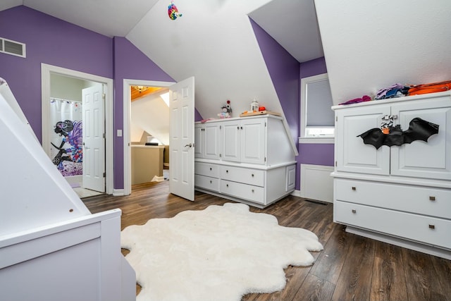 bedroom featuring dark wood finished floors, visible vents, and vaulted ceiling