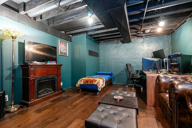 bedroom with a fireplace and wood finished floors