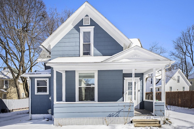 view of front of property with covered porch and fence