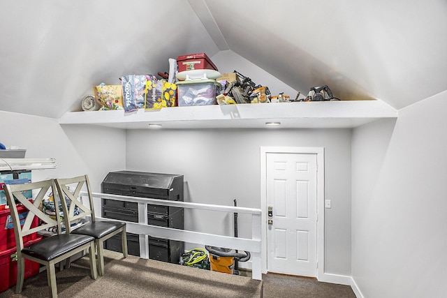 interior space featuring vaulted ceiling, carpet floors, and baseboards