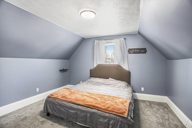 bedroom featuring carpet, baseboards, vaulted ceiling, and a textured ceiling