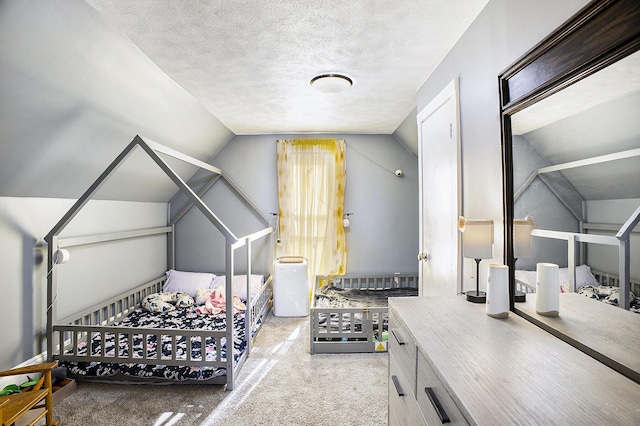 bedroom featuring carpet, vaulted ceiling, and a textured ceiling