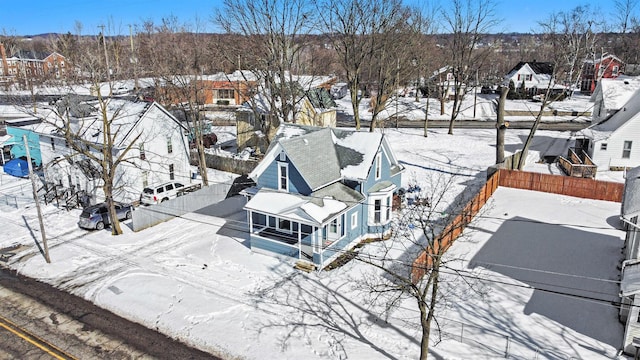 snowy aerial view featuring a residential view