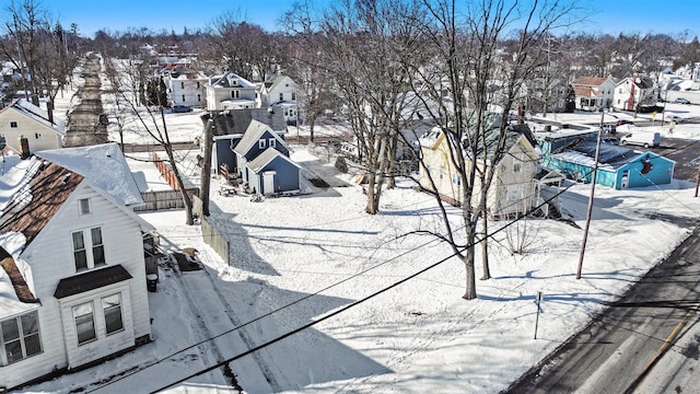 snowy aerial view with a residential view