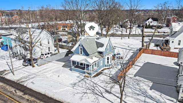 snowy aerial view featuring a residential view