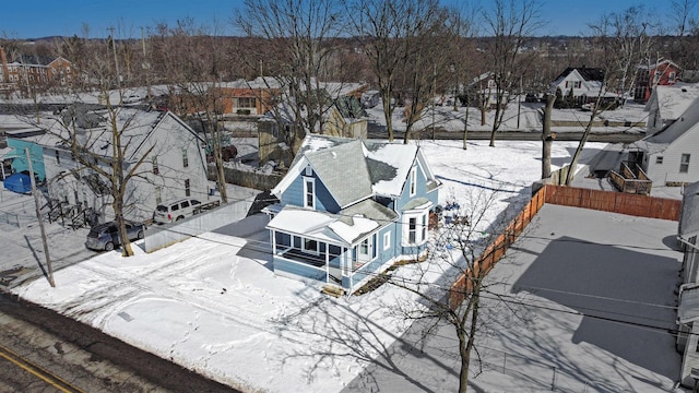 snowy aerial view with a residential view