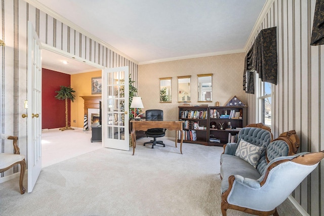 carpeted office space featuring ornamental molding, french doors, a lit fireplace, and wallpapered walls