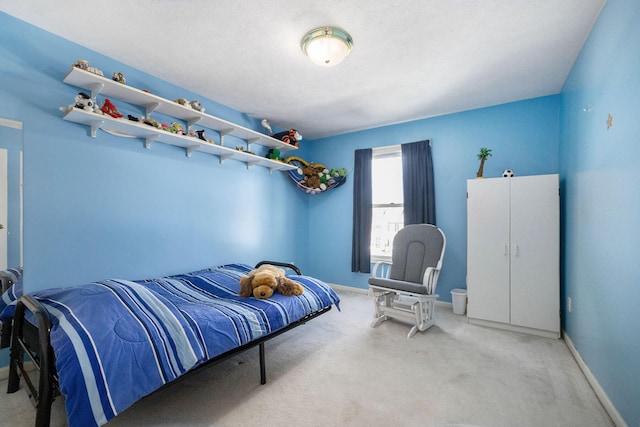 bedroom with carpet floors and baseboards