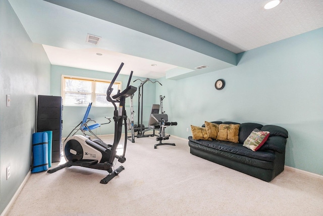 workout room featuring visible vents, baseboards, and carpet flooring