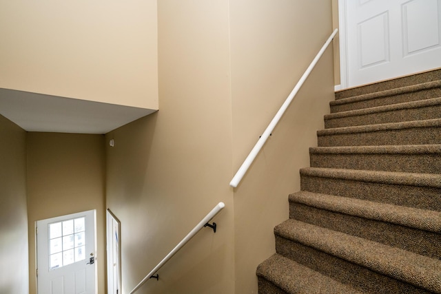 staircase featuring a high ceiling