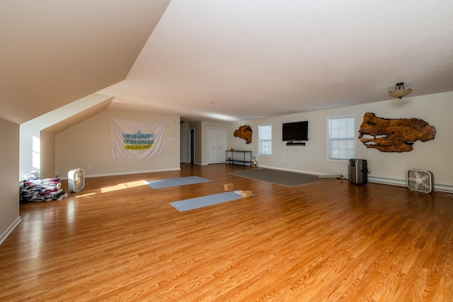 workout area featuring wood finished floors and baseboards