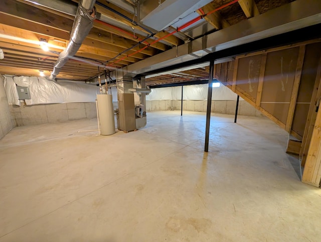 unfinished basement with electric panel, heating unit, and water heater