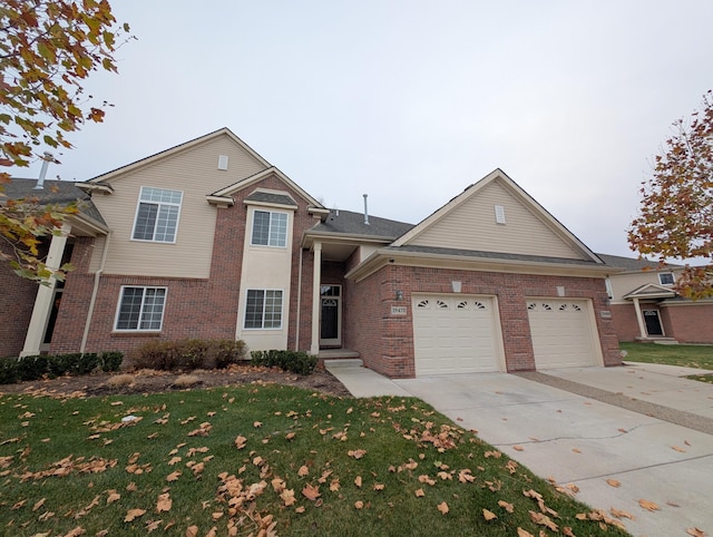 traditional-style home featuring a garage, driveway, brick siding, and a front lawn