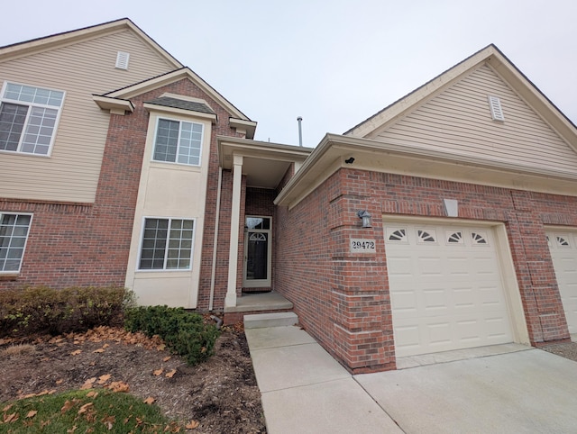 view of front of home with a garage and brick siding