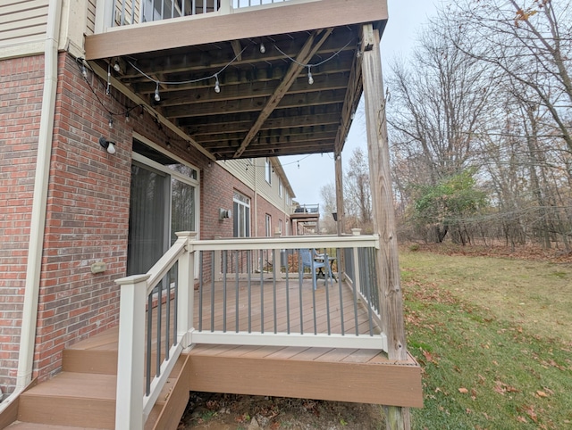 wooden terrace with a lawn