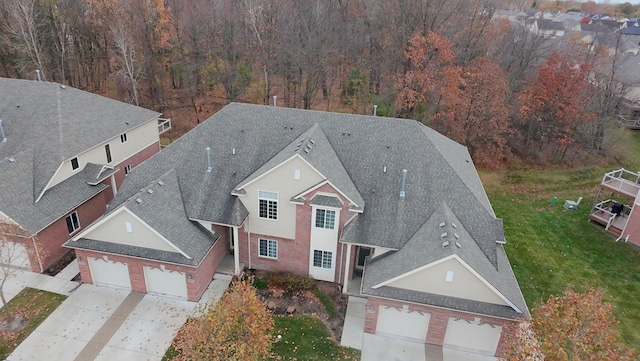 birds eye view of property with a forest view