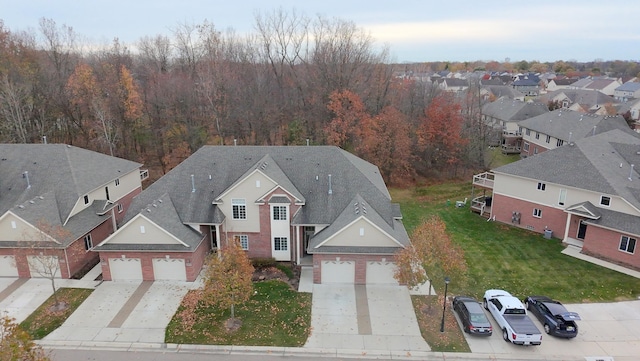 birds eye view of property with a forest view and a residential view