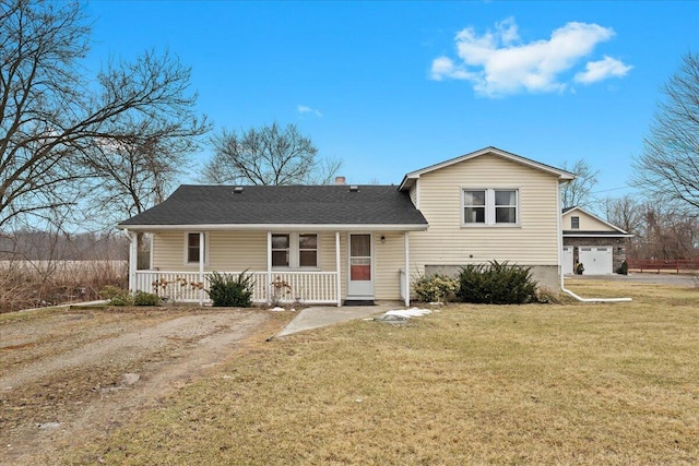 split level home with covered porch, a front lawn, and roof with shingles