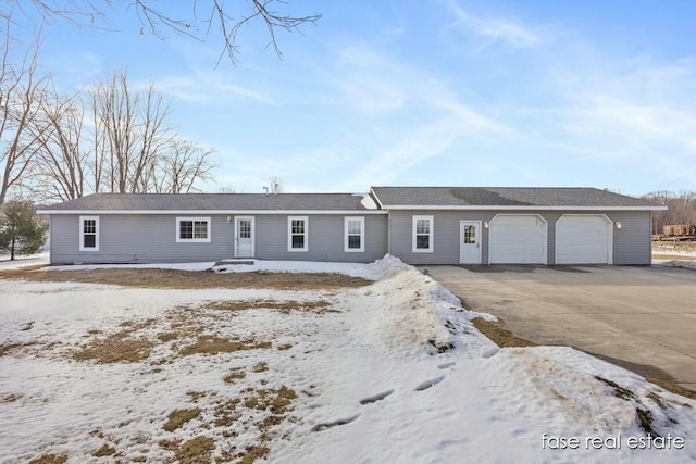 single story home featuring driveway and an attached garage