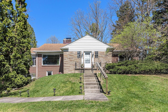 bungalow featuring a shingled roof, a chimney, a front lawn, and brick siding