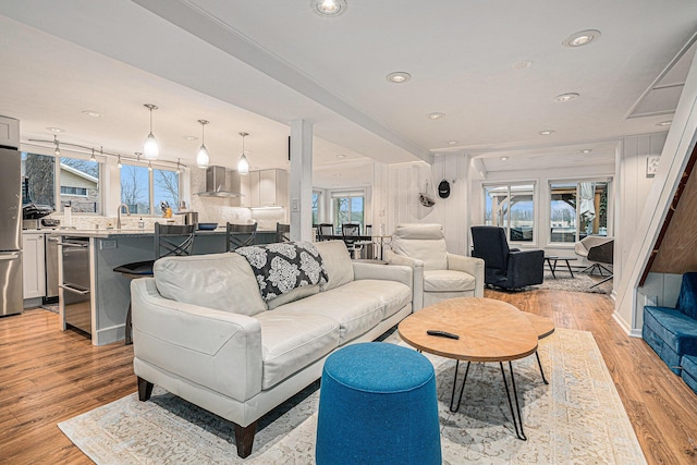 living room with recessed lighting and light wood-style flooring