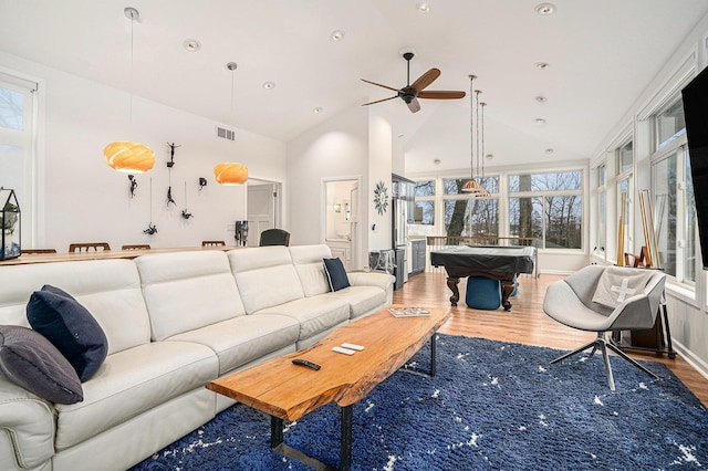 living room with visible vents, wood finished floors, high vaulted ceiling, and ceiling fan