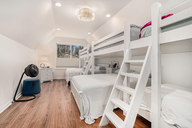 bedroom featuring lofted ceiling, recessed lighting, wood finished floors, and baseboards