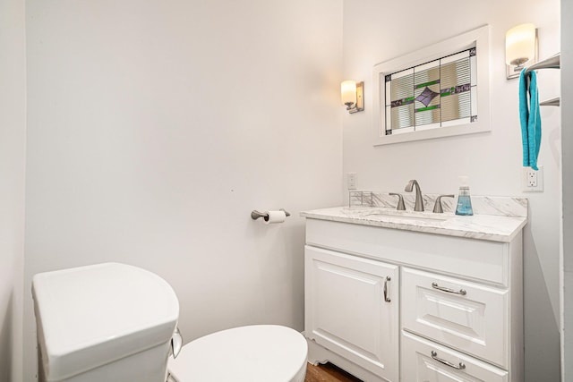 bathroom with toilet and vanity