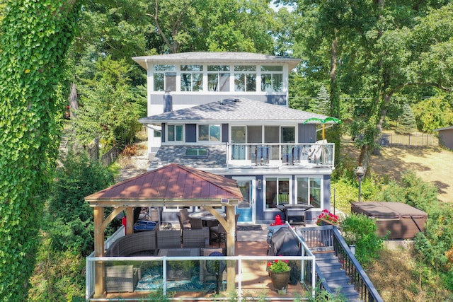 view of front of home featuring an outdoor living space, fence, a gazebo, a shingled roof, and a balcony