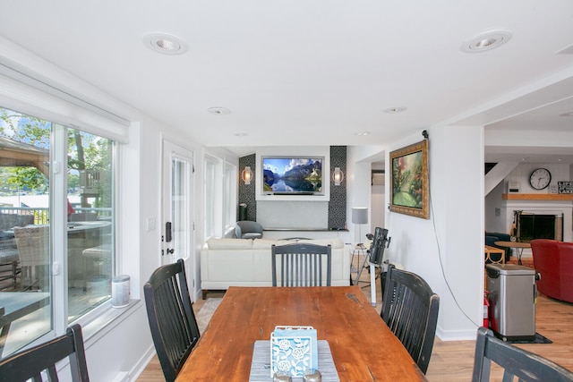 dining space with light wood finished floors and baseboards