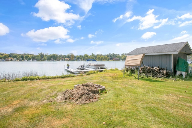 view of yard featuring a boat dock and a water view