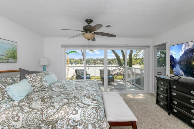 bedroom with access to exterior, visible vents, multiple windows, and carpet floors