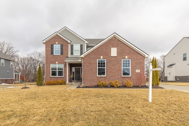 traditional-style home with a front yard and brick siding