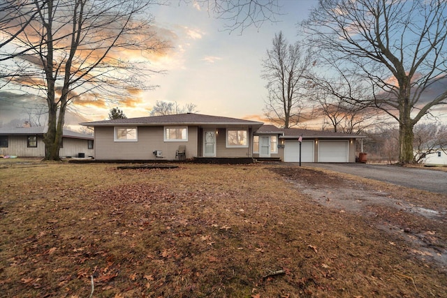 ranch-style house featuring driveway and a garage