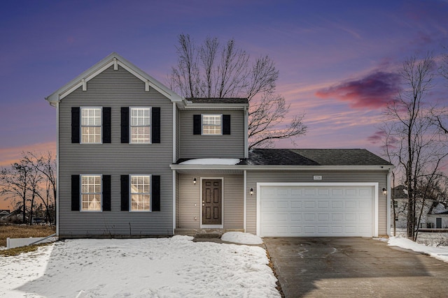 traditional home with a garage and driveway