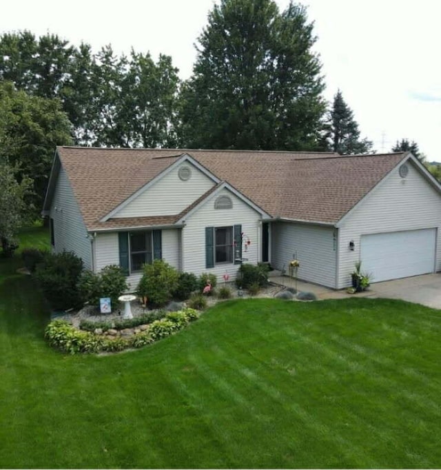 ranch-style home featuring a garage, concrete driveway, and a front lawn