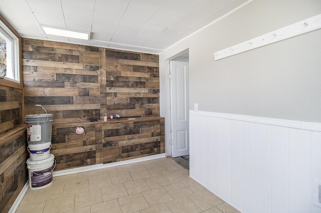 interior space with wooden walls, visible vents, and wainscoting