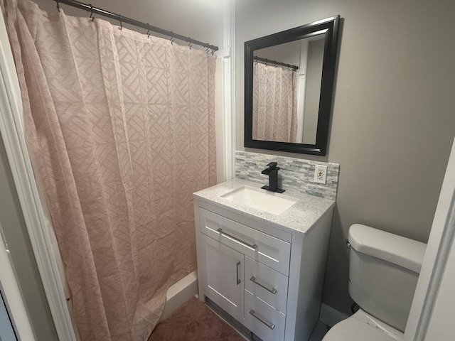 bathroom featuring vanity, backsplash, toilet, and a shower with curtain