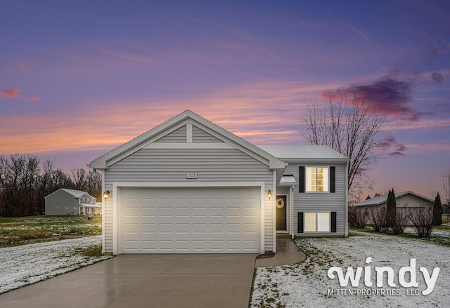 view of front of home with a garage and concrete driveway