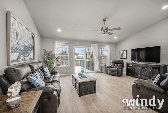 living room with vaulted ceiling, recessed lighting, light wood-style flooring, and a ceiling fan