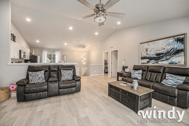 living area with recessed lighting, visible vents, vaulted ceiling, and light wood finished floors