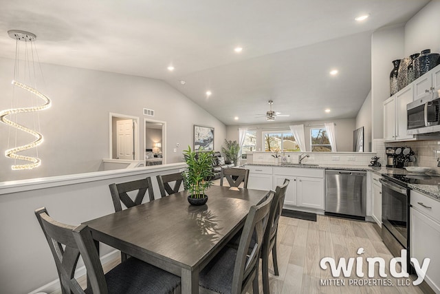 dining room with recessed lighting, visible vents, vaulted ceiling, ceiling fan, and light wood-type flooring