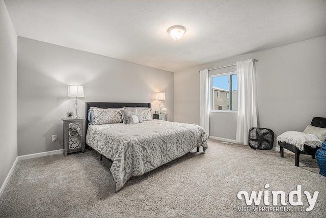 bedroom featuring carpet and baseboards